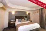 Cama king size de la Suite Master Hotel Ticuán Tijuana